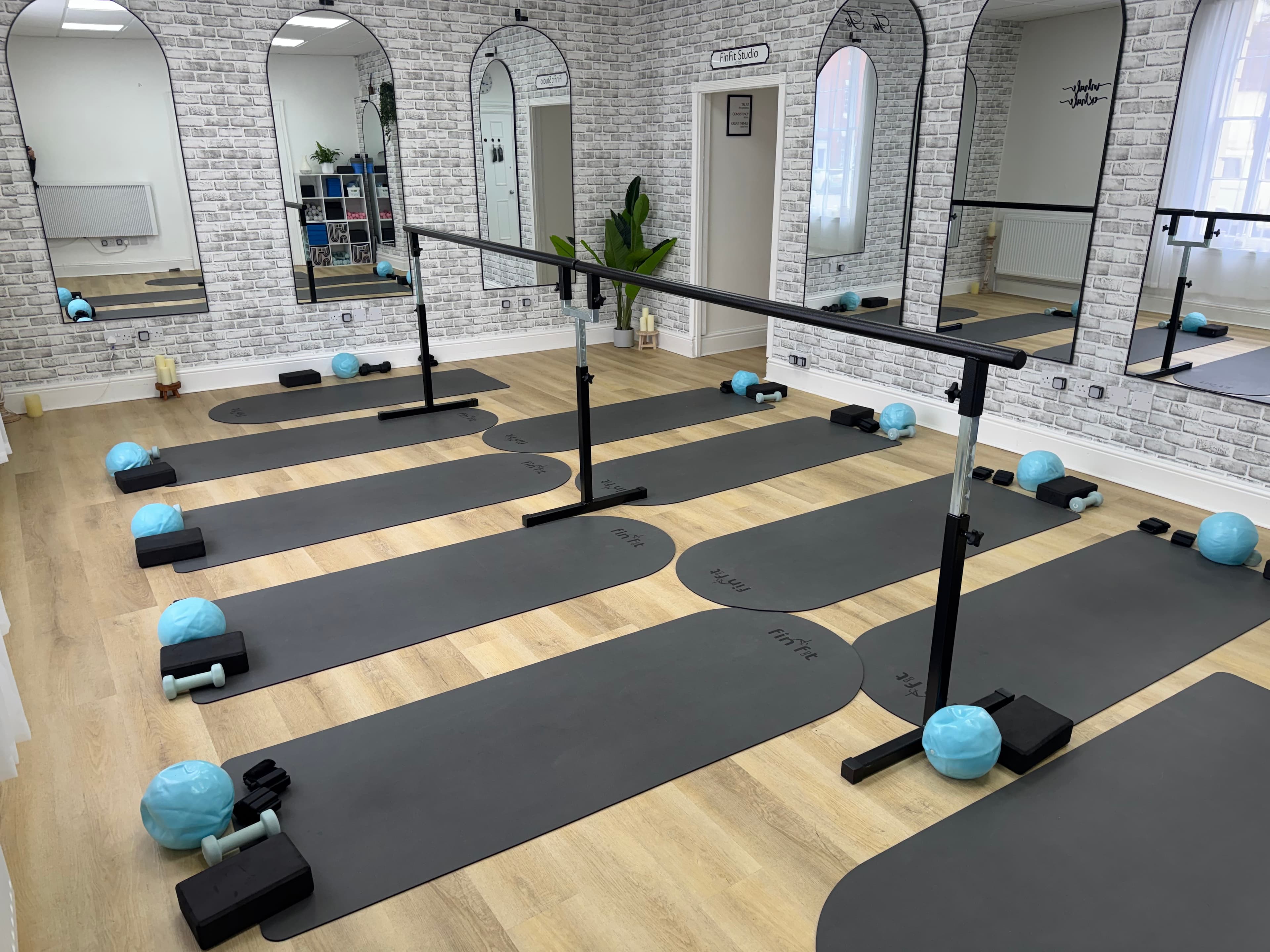 Studio mats set up with soft balls, foam blocks and light dumbbells