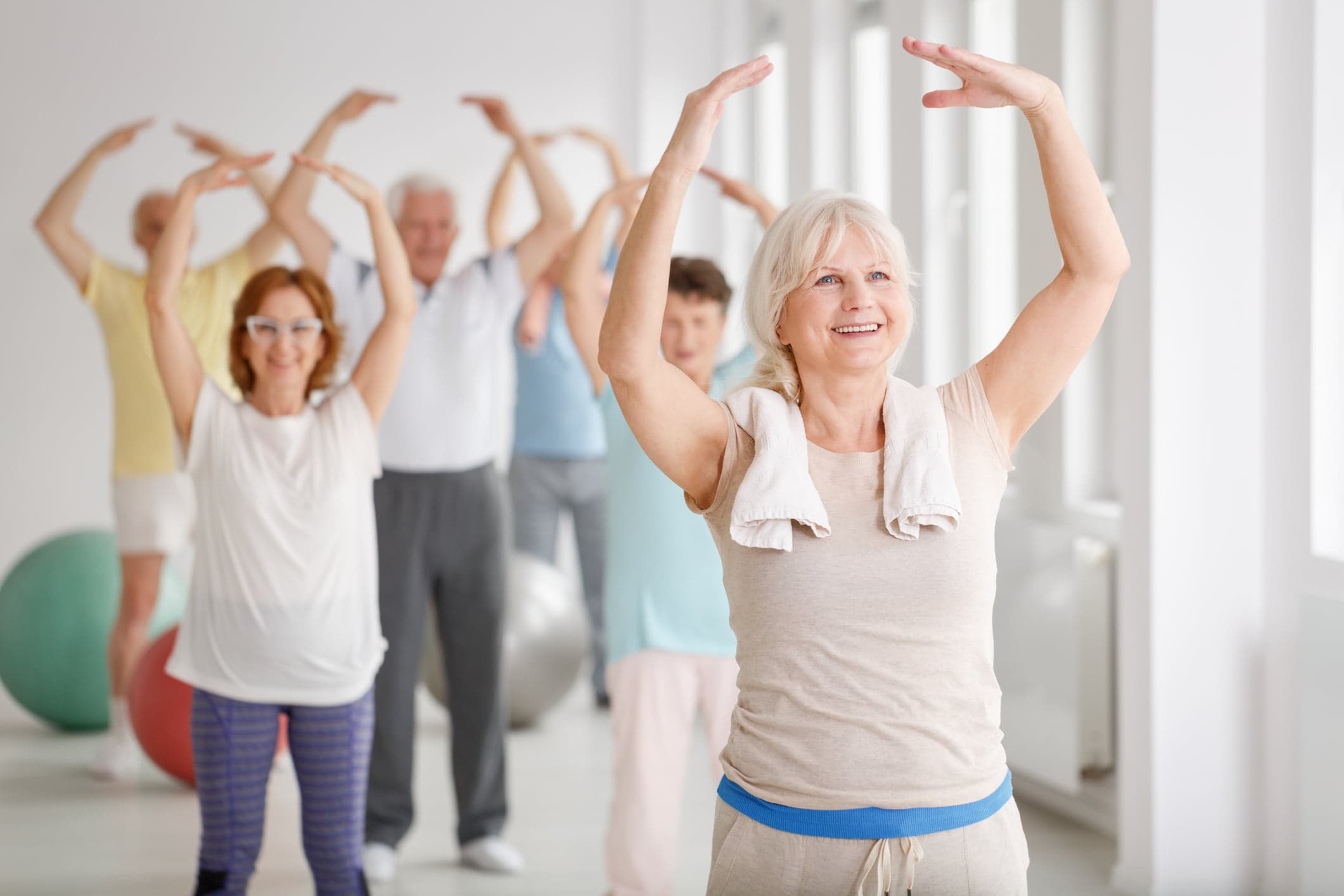 Keep fit class for over-60s, arms overhead